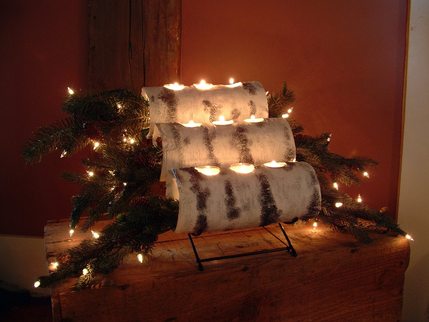 Three tier birch yule log cradle with birch logs and prelit Three tier birch Yule log cradle with birch logs and prelit evergreen boughs are right at home in the fireplace. Add a warm touch to your fireplace in the off season or on those nights when you just wan to cozy up the room a little. All of my birch pieces are made of plaster cast in