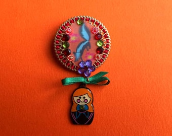 Russian doll and animal brooch