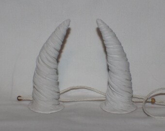 Small devil inspired white horns with a twisted pattern