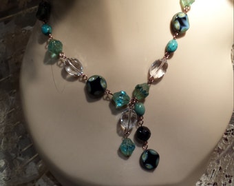 One strand necklace with center drop