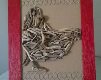 chicken on red frame with driftwood and wire