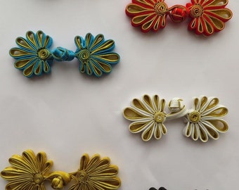 2 sets of hand-stitched frog fasteners trims, choice of colours with gold.