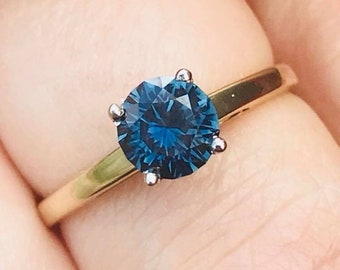 Stunning .80 ct Australian sapphire set in 14 kt gold and platinum head size 6