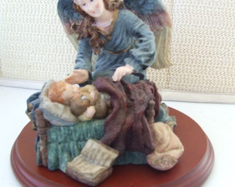 Angel Watching Over Sleeping Child....resing figurine