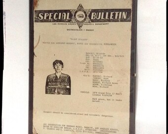 Aged reproduction Richard Ramirez Nightstalker wanted poster in clip frame.
