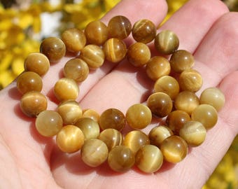Multicolored 8 mm, 4 round gold Tiger eye beads.