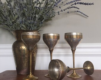 Set of four vintage brass and silver goblets