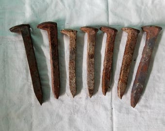 Seven railroad spikes, four vintage