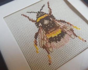 Cross Stitch Bee in Black frame.