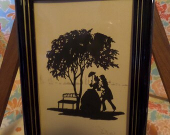 Framed Silhouette of courting couple under tree