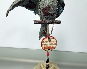 Heartsongs - Where He Leads Me is an altered wood poker chip with hymn snippets, metal findings, and charms
