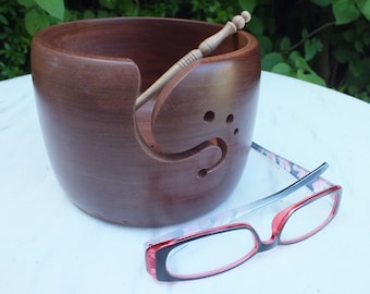 Yarn bowl hand turned from sapele wood with 3 holes and a curved notch for yarn. A beautiful and practical addition to any crafter's space.