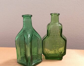 Two vintage Green Glass Wheaton Bottles, Kings Patent Balsam of Life and Cathedral Chief Wahoo Electric Tonic