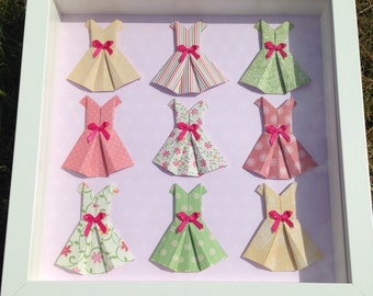 Box frame with mini origami dress.