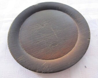 Old wooden round plate serving saucer