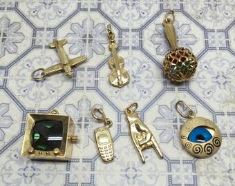 Vintage 14k charm airplane/ violin / viola/ cello/ Maraca/ cell phone/ TV television/ Evil Eye / hand