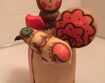 Folk Art Wooden doll with a chicken