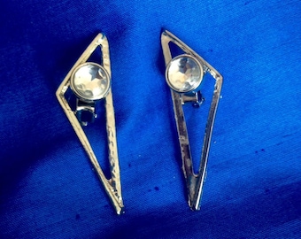 Silver tone triangle clip earrings.