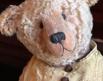 Vintage looking mohair teddy bear.fully dresses with vintage shoes.
