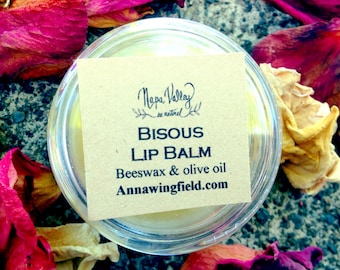 Bisous (kiss-in French) lip balm in 10ml plastic container.