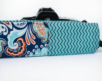 DSLR camera strap cover with lens cap pocket. blue and aqua paisley with chevron.