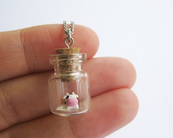 Micro cow in a tiny bottle