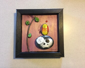 Painted stone cat with a bird