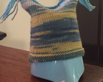 Hand knitted flat-topped hat with tassels