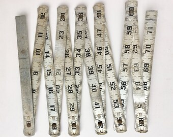 vintage folding metal ruler yardstick, aluminum folding ruler, vintage tool, industrial object, vintage woodworker
