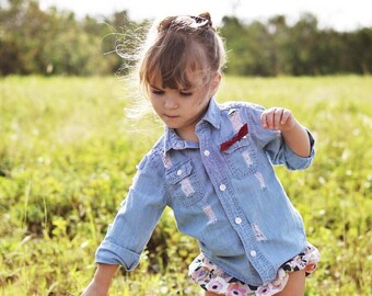 SOLD OUT. Restock soon. Distressed Chambray Button Up Shirt. Long Sleeve or cutoffs option.