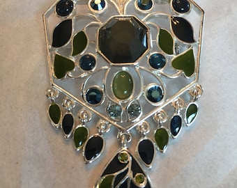 Silvertone pin with dangle accents. Nice colors