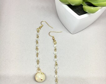 Long drop earrings on gold and bead chain