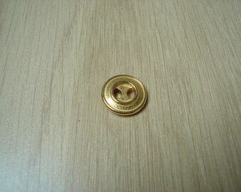 button round gold tone metal with several edge