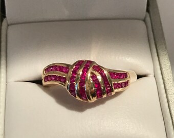 14k yellow gold and Ruby "Knot" ring. .65ctw. 9mm wide. Sz 7 weight 3.3 grams