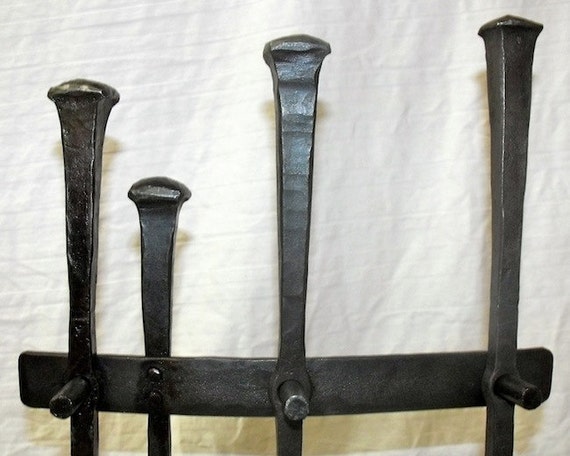 Rustic Wrought Iron Fireplace Tool Set Very traditional and rustic in appearance. Each tool is split and drifted and hang on individual pegs attached to the stand. 1/2 stock used. Stand base is 12x8and sits on 4 iron balls