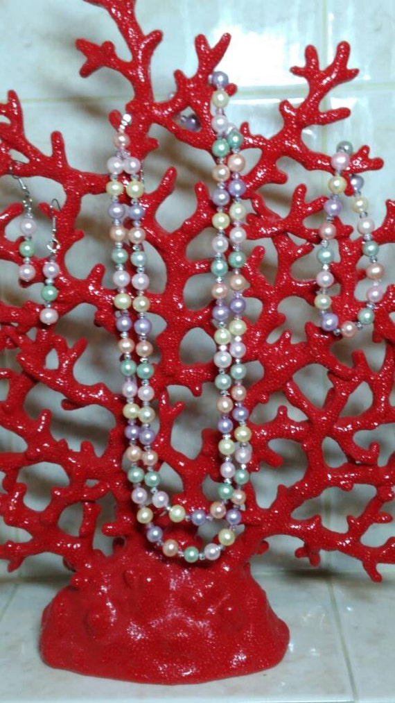 Double strand necklace of multicolored freshwater pearls with matching earrings and bracelet. Pink, Pistachio, Peacock and Golden Yellow.