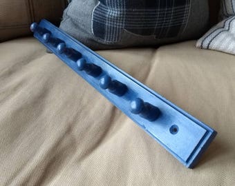 Shaker style chalk painted peg rail.