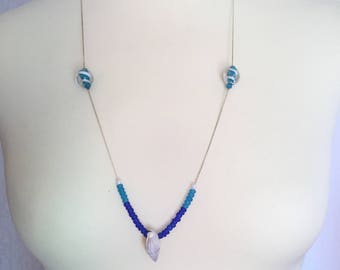 Silver necklace with blue pearls and shell