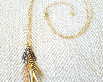 Gold tone necklace with bronze feather accent charms