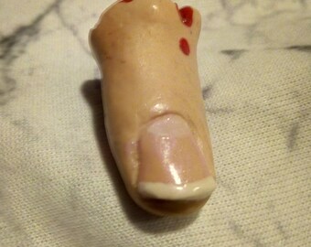 Severed finger pendant