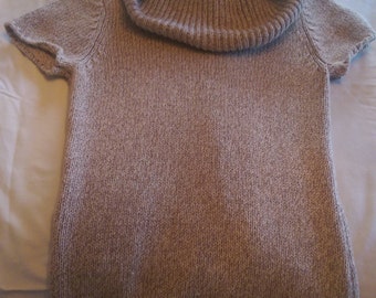 Soft and warm,tight knit,multi-colored beige sweater is small size,with a large neck,short sleeves and ribbed trim on bottom of the sweater