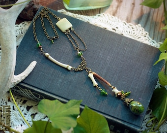 woodland necklace with bones, beads, and a moss-filled vial