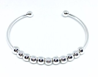 Bracelet silver metal and balls.