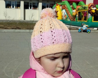 Spring/Fall hand knitted hat for a child with a pompom