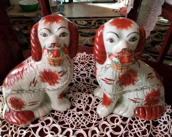 Two delightful staffodshire dogs with flower baskets