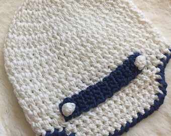 Knitted white hat with a visor