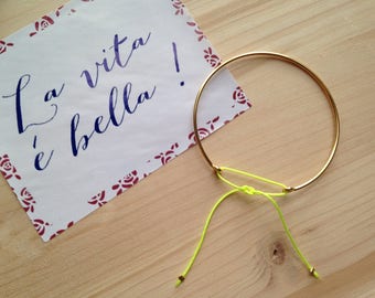 Bangle is plated 14 k - neon yellow cord