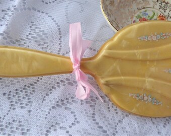 A very pretty Art Deco hand mirror in lemon celluloid with hand painted floral decoration in pink and blue. A great gift! c1930.