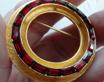 Vintage lovely circle brooch with baguette cut deep red glass stones
