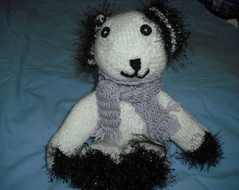very cute little bear made by hands with yarn in white and black speckled
